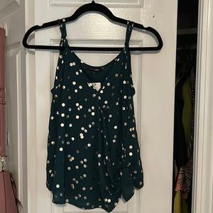 Green Tank with Gold Polkadot detail and adjustable straps. Tie Detail on Hem.
